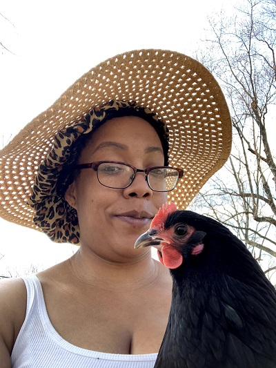 Antoinette Lewis tending to her chickens in her backyard farm in Chicago, Illinois.