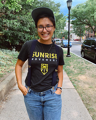 smiling person wearing Sunrise Movement t-shirt