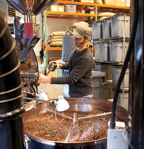 Grounds for Change employee Michael Williams roasts coffee beans in Poulsbo, Washington. Photo courtesy Grounds for Change