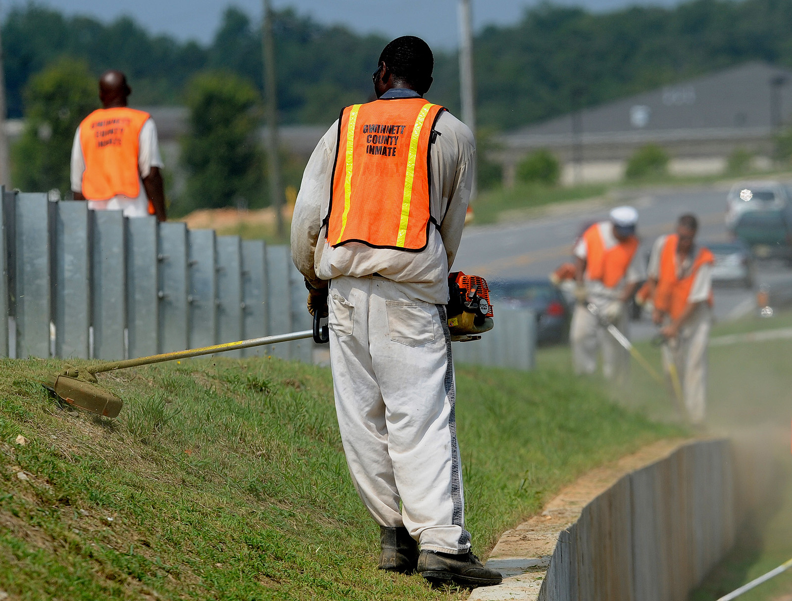 prison laborer working on the side of the road