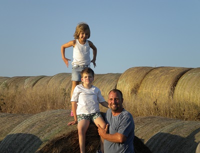 Seth Watkins with his children Spencer and Tatum, on their family farm, in 2010. Photo by Christy Watkins.