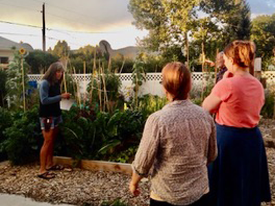 group of people learning about seed saving in the garden