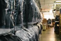 Image: suit rack at dry cleaners. Topic: Green Dry Cleaning