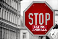 "Stop eating animals" on a stop sign, plant-based investing is a growing trend