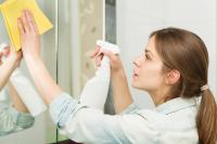 woman spraying cleaning product