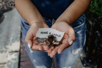 hands holding coin change with words saying "make a change"