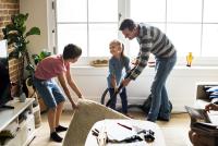 Image: dad and kids vacuuming, creating a germ-free home
