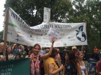 Shareholder activists from the Interfaith Center on Corporate Responsibility urge others to join them in addressing companies’ lack of action on global warming at the People’s Climate March in 2014. 
