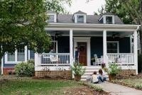 family in front of a blue house