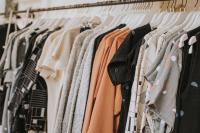 Image: clothes hanging on hangers in shop. Topic: 5 ways to shop for sustainable clothes online