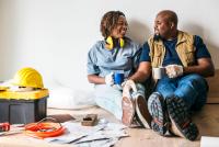 An African American couple taking a break during a home rennovation.