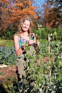 Lisa standing buy a trellised bean plant on an autumn day