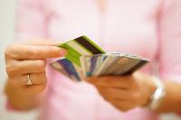 Image: person holding multiple credit cards. Topic: Find A Socially Responsible Credit Card