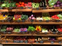 assorted fruits on brown wooden shelves