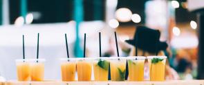 Row of drinks with plastic straws