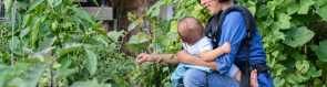 NIcky Schauder weeding with her child in the tiny garden