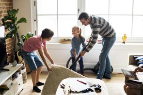 Image: dad and kids vacuuming, creating a germ-free home
