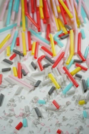 A close up shot of different colored straws that have been cut into smaller and smaller pieces.
