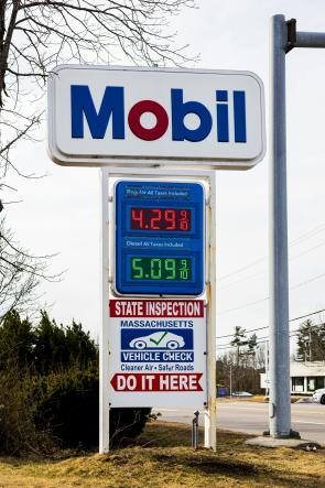A sign of prices at a gas station.