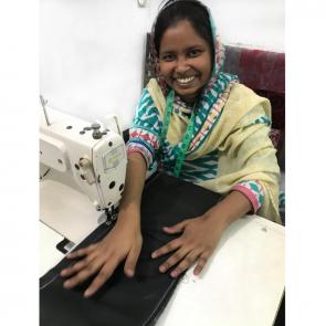 Fair trade production with sewing machine and Shani's smile.