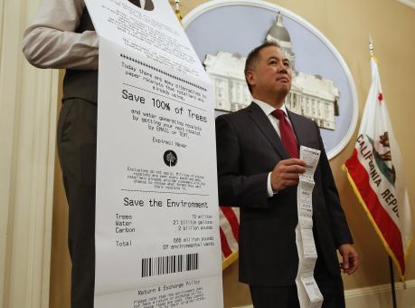 Assemblyman Phil Ting, D-San Francisco, displays a long paper receipt as he discusses his bill to require businesses to offer electronic receipts, Tuesday, Jan. 8, 2019, in Sacramento, Calif. Under the legislation customers could receive a paper receipt on request. (AP Photo/Rich Pedroncelli)