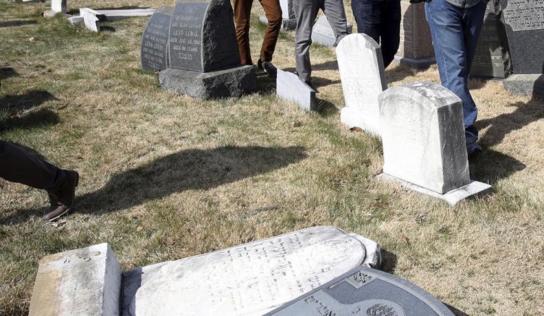 Ahmadiyya Muslim volunteers walk through Mount Carmel Cemetery in Philadelphia, where vandals desecrated Jewish headstones in February