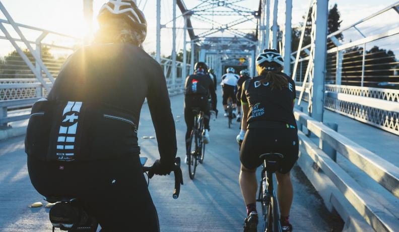 Image: people biking in performance clothing on a bridge. Topic: The Trouble with Nanoparticles in Clothing