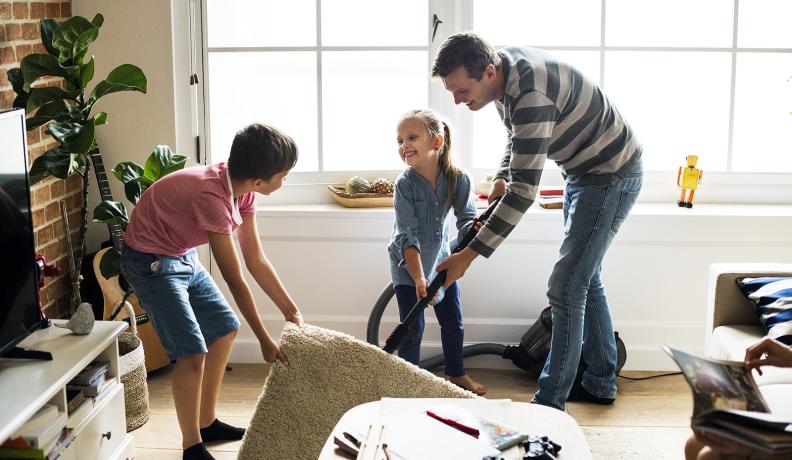 dad and kids vacuuming