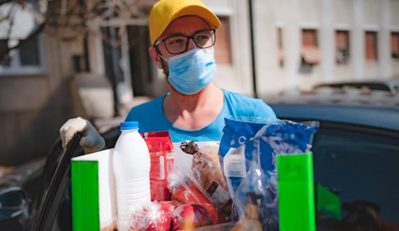 man participating in mutual aid while wearing mask