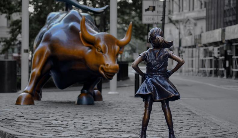 girl in front of bull statue wall street