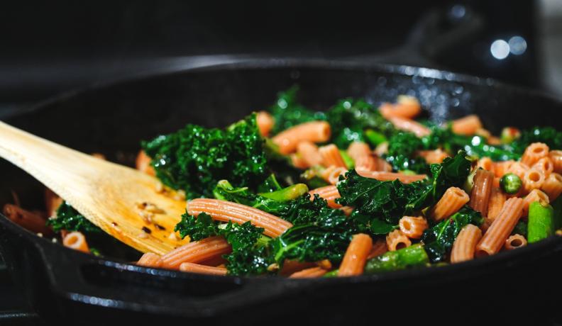 pasta and kale on a cast iron