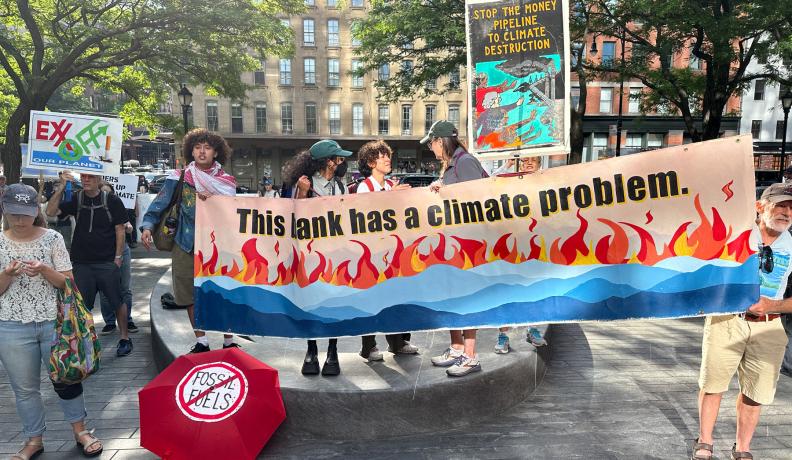 Protesters hold a sign that says "This bank has a climate problem" outside of Citibank headquarters in New York City on June 13, 2024.