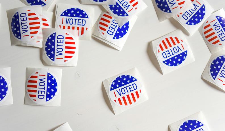 I voted stickers scattered across a white table.