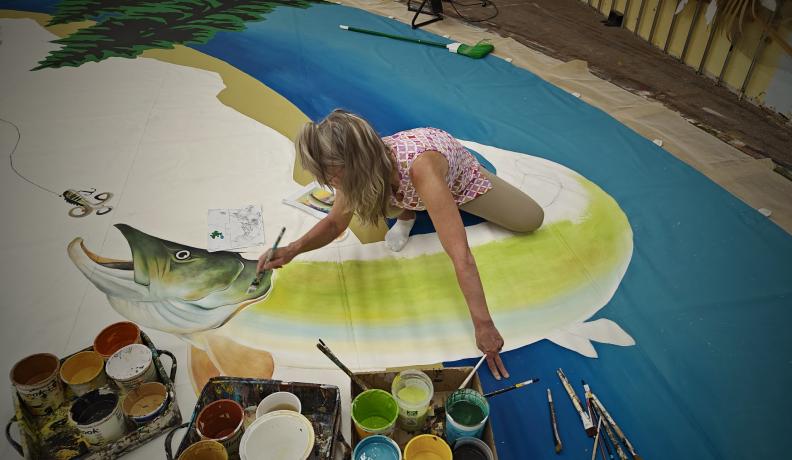 Kris Lawler, Nomadics’ art director, painting a custom tipi. Nomadics is a certified Green Business Network member. Photo credit: Nomadics Tipi Makers.