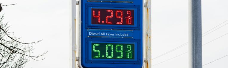 A sign of prices at a gas station.