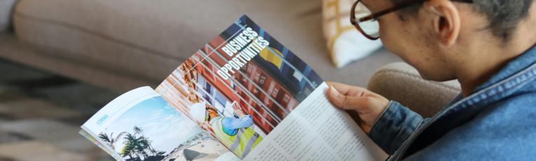 generic photo of a person reading a print magazine