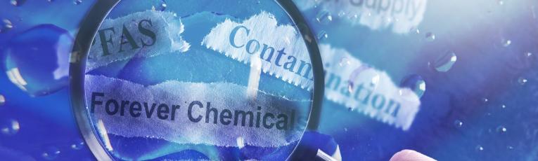 A magnifying glass zooming in on the phrases "forever chemicals," "PFAS," and "contamination."