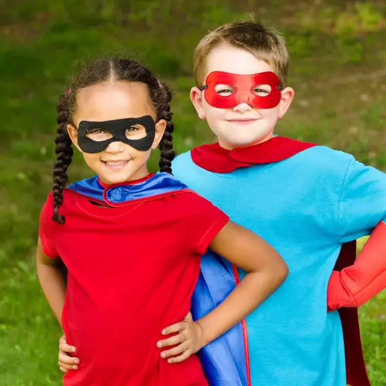 Image: two kids in costumes. Topic: Green Your Halloween: From Organic Candy to Nontoxic Face Paint
