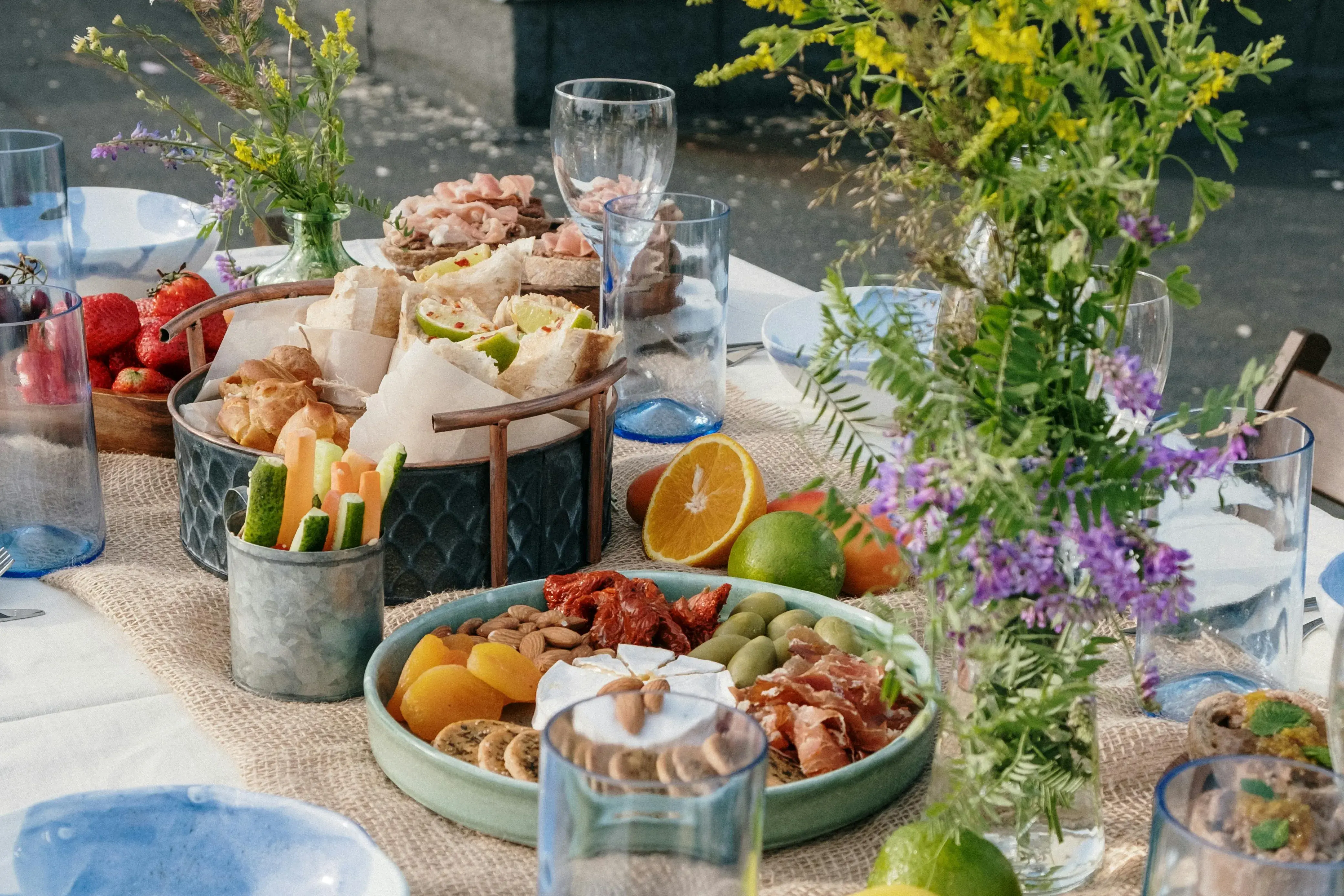 A spread of vegetables, herbs, fruit on a set table