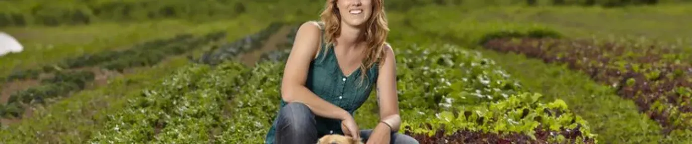 Photo of author with her dog on the farm.