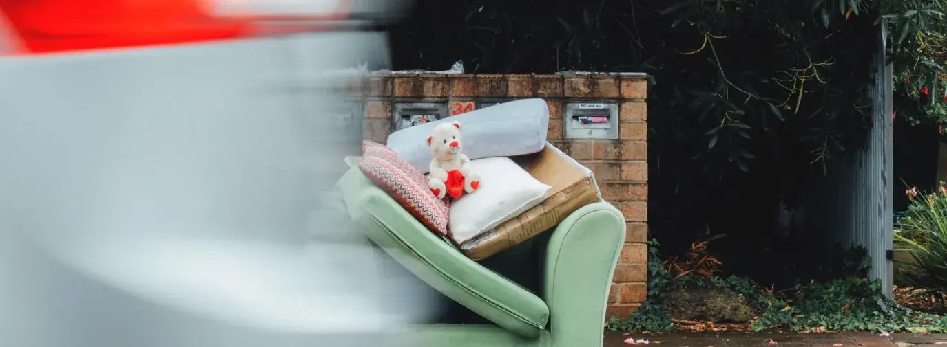 Image: couch and teddy bear left on the sidewalk. Title: How a quest to sustainably unload unwanted stuff led Deron Beal to found Freecycle.