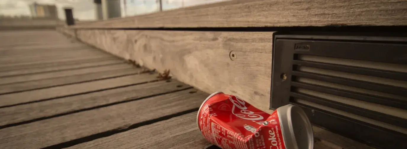 can of coke on sidewalk