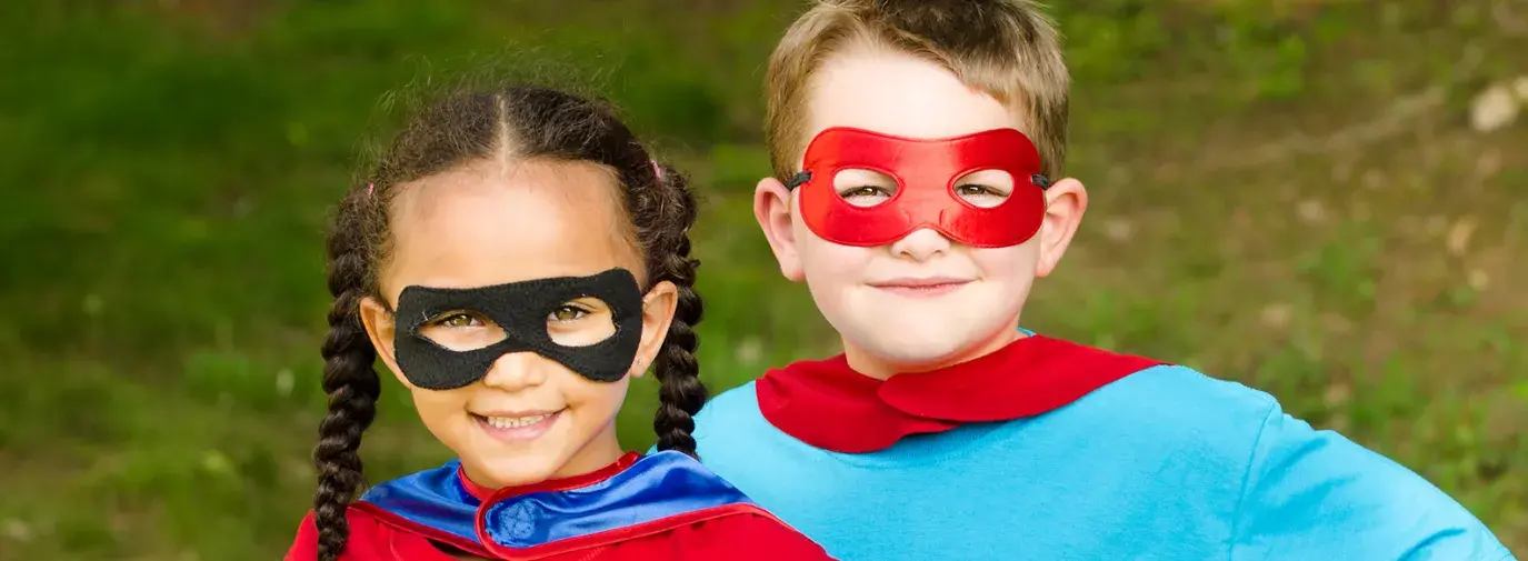 Image: two kids in costumes. Topic: Green Your Halloween: From Organic Candy to Nontoxic Face Paint