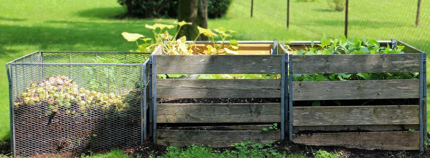 Image: compost bins in a yard. Topic: Methods of Regenerative Agriculture: #4 Composting