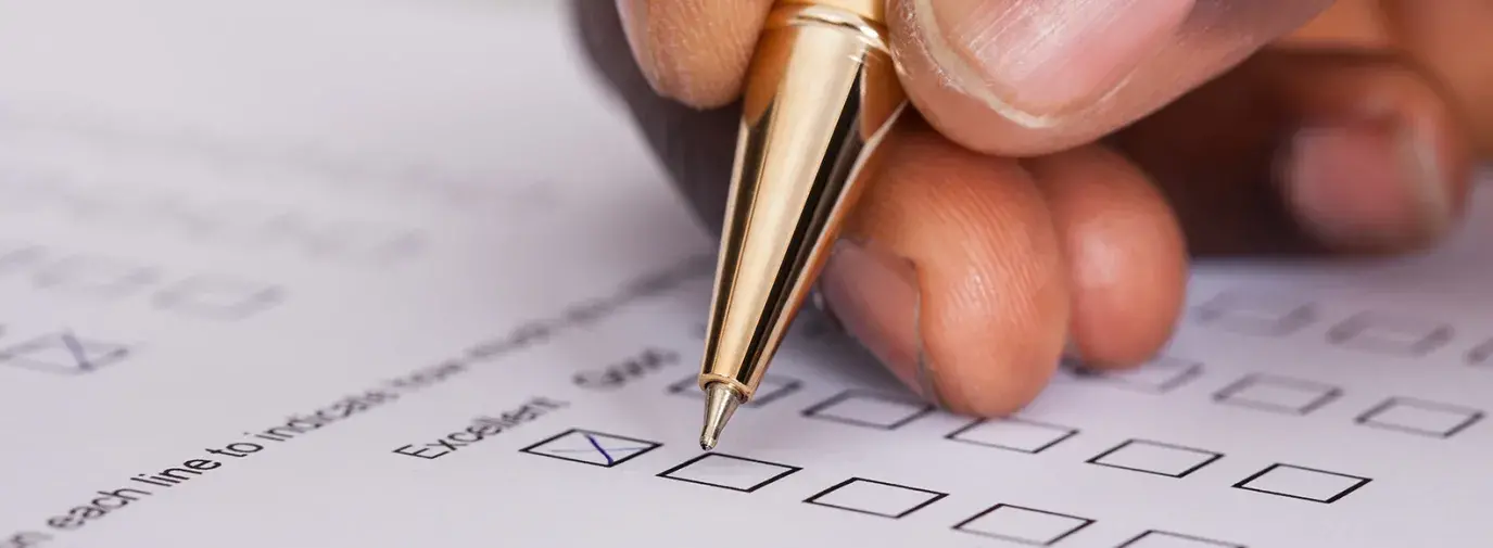 Image: pen in hand signing a ballot. Title Holding Companies Accountable through Shareholder Activism