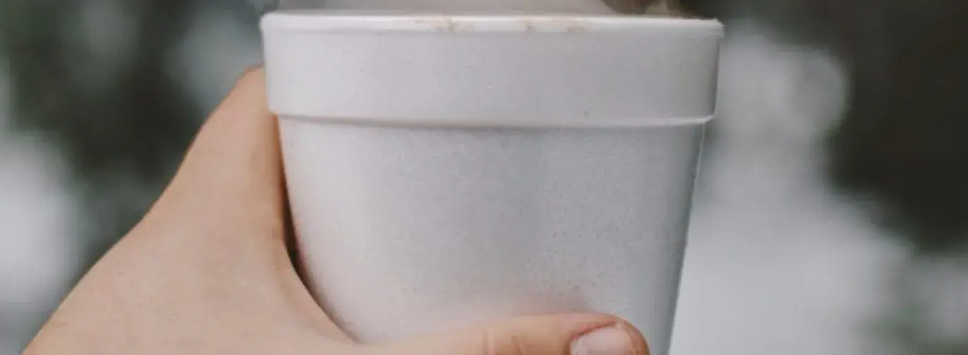 Hand holding a polystyrene cup, no longer allowed with NYC's Polystyrene Ban