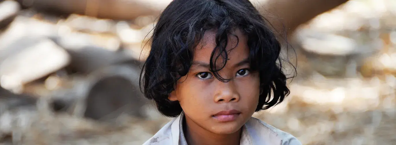 Image: sad child. Title: Stop Sweatshops and Child Labor