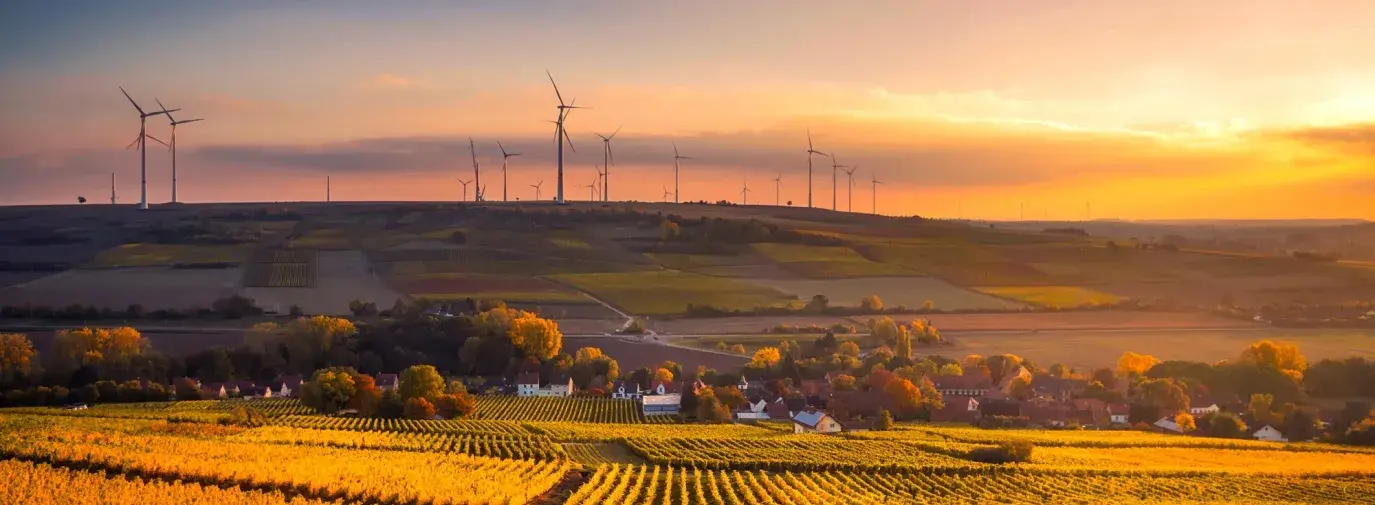 Image: windmills on the horizon of farmland. Title: Verizon Sets Major New Clean Energy Goal in Response to Pressure From More Than 30,000 Consumers