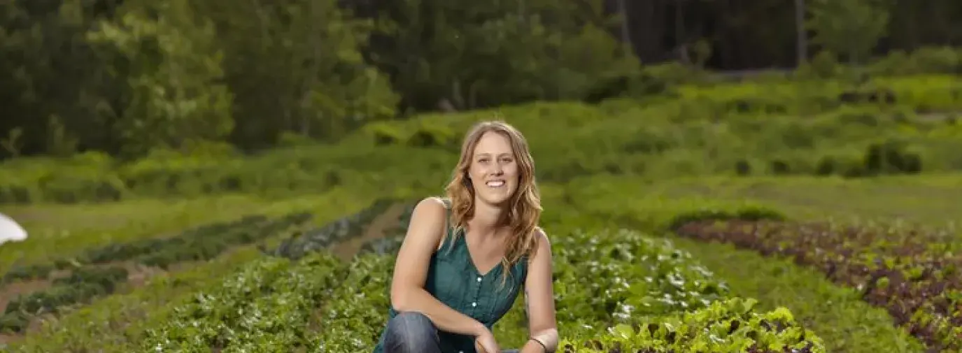 Photo of author with her dog on the farm.