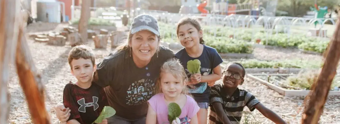 Image: Kim and students at the school farm. Title: Inspiring Future Climate Victory Gardeners at Moss Haven Elementary
